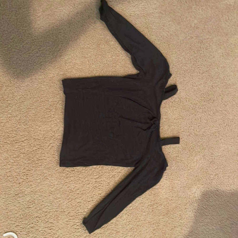 It is a black long sleeved shirt with shoulders out